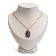 dreampunk.arts Aeriselle-Eliyra Starlight pendant featuring a purple amethyst stone with a gold star on a gold chain.