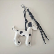 dreampunk.arts white and black spotted dalmatian dog charm with a black cord and silver carabiner clip