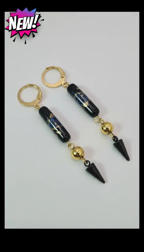 dreampunk.arts floral spike earrings featuring black cylindrical beads, gold accents, and sharp black spike charms.