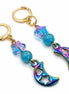 dreampunk.arts gold stainless steel earrings featuring iridescent crescent moon charms and blue star glass beads