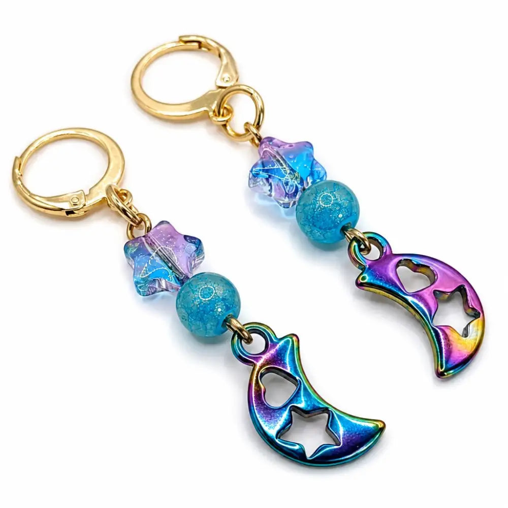 dreampunk.arts gold stainless steel earrings featuring iridescent crescent moon charms and blue star glass beads
