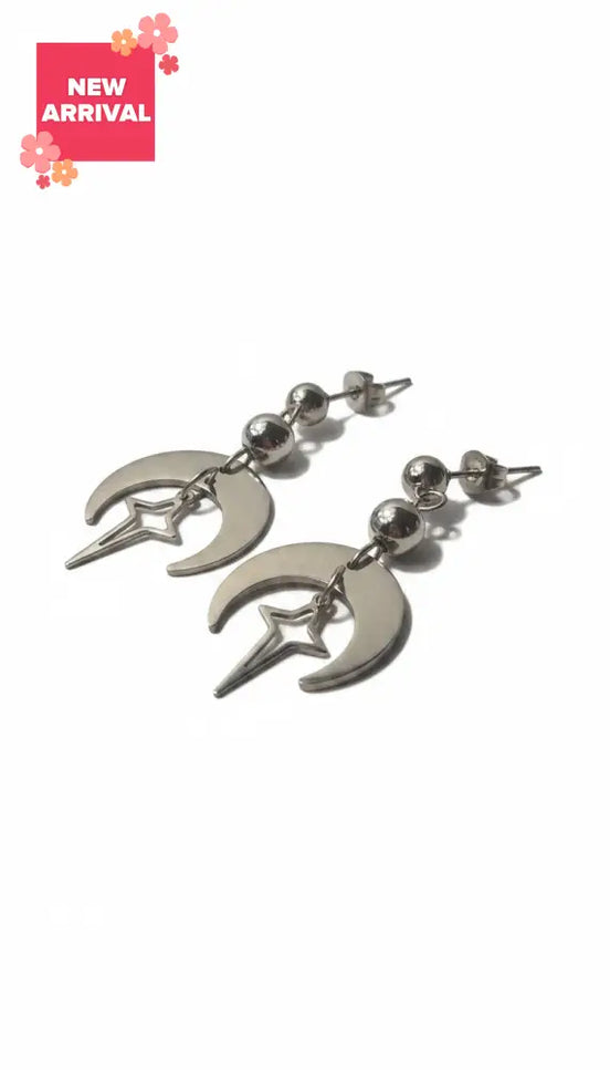 dreampunk.arts silver-toned hollow moon earrings featuring a dangling star charm and metallic bead accents