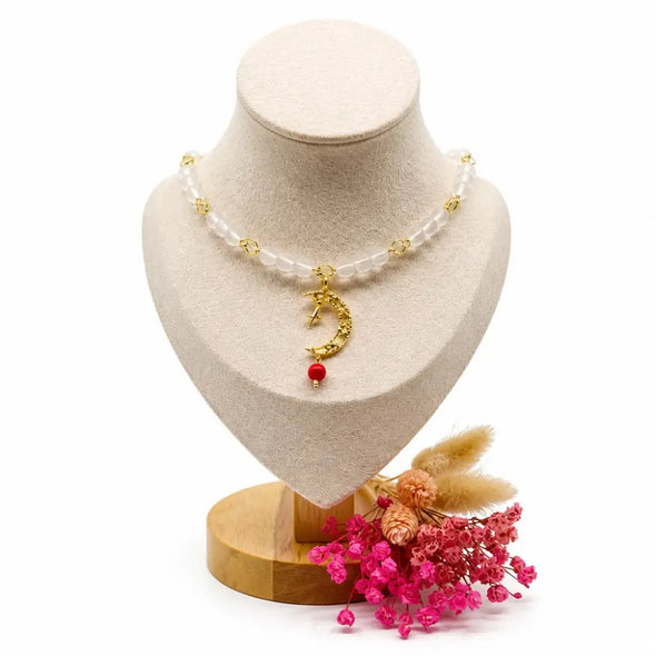 dreampunk.arts Mage the Red Moon necklace with white glass beads, gold moon charm, and red accent on a display bust