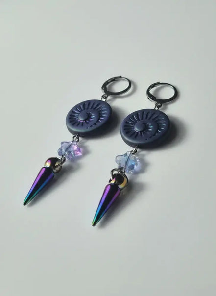 dreampunk.arts Mystic Shell Spike earrings featuring iridescent spiral shells, star beads, and rainbow metal spikes.